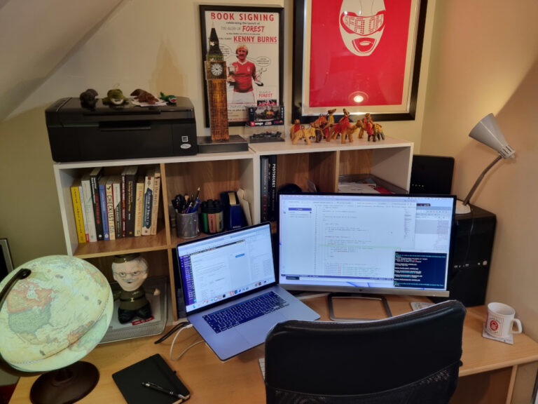 Work desk with laptop, printer and books